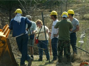 A work crew for Urbandale putting up a fence near the entrance to Kanata Lakes. Photo is from 2002.