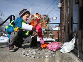 An Ottawa family leave flowers and home made cards at the Ottawa Mosque on Northwestern Ave in Ottawa Monday January 30, 2017. Their family wanted to show their support to their Muslim neighbours following a terrorist attack on a Quebec City mosque late Sunday.