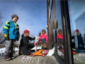 An Ottawa family leave flowers and home made cards at the Ottawa Mosque on Northwestern Ave in Ottawa Monday January 30, 2017. The family wanted to show their support to their Muslim neighbours following a terrorist attack on a Quebec City mosque late Sunday.