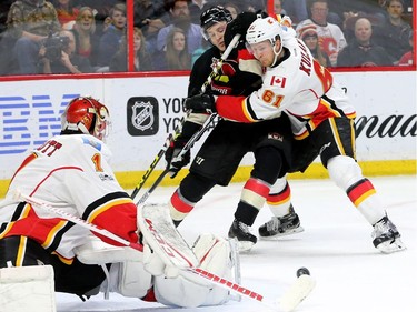 Ottawa newcomer Tommy Wingels battles Calgary's Brett Kulak in front of Brian Elliot's net during first-period action between the Ottawa Senators and Calgary Flames at Canadian Tire Centre Thursday (Jan. 26, 2017). Julie Oliver/Postmedia