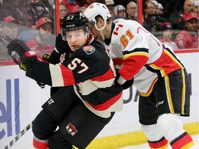 Tommy Wingels (left) battles with Calgary's Brett Kulak in the corners during first-period action between the Ottawa Senators and Calgary Flames at Canadian Tire Centre Thursday (Jan. 26, 2017).