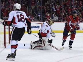 Ottawa Senators goalie  Mike Condon reacts after a goal by Washington Capitals defenceman Karl Alzner, not seen. The Capitals' Justin Williams and the Senators' Ryan Dzingel are also pictured.
