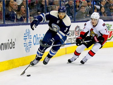 COLUMBUS, OH - JANUARY 19:  Seth Jones #3 of the Columbus Blue Jackets attempts to skate the puck away from Kyle Turris #7 of the Ottawa Senators during the first period on January 19, 2017 at Nationwide Arena in Columbus, Ohio.