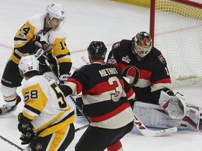 Ottawa Senators Mike Condon makes a save against Pittsburgh Penguins Chris Kunitz during first period  at the Canadian tire Centre in Ottawa Thursday Jan 12, 2017.