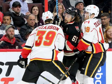 Ottawa's Erik Karlsson Gets sandwiched between Calgary's Alex Chiasson and Matthew Tkachuk (right) during first-period action between the Ottawa Senators and Calgary Flames at Canadian Tire Centre Thursday (Jan. 26, 2017). Julie Oliver/Postmedia