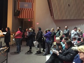 Parents line up at the microphone Tuesday night Jan. 19, 2017, to speak at a public meeting about proposed school closures in the west end of Ottawa.