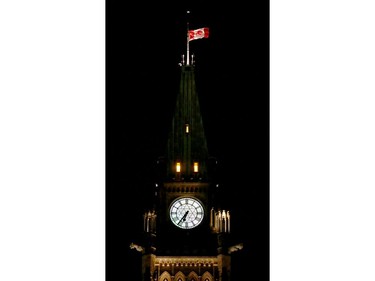 Parliament Hill's flag flies at half mast in remembrance of the victims. More than 1,000 people came out to a candlelight vigil for the victims of the Quebec mosque attack Monday (Jan. 30, 2017) in front of Parliament Hill's eternal flame. Julie Oliver/Postmedia