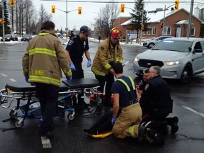 First responders team up to assist a pedestrian struck Thursday.