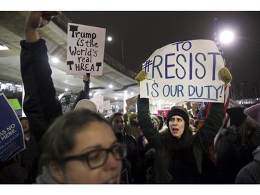 Protesters gather at O'Hare International Airport after more than a dozen people were detained, including green-card holders, Saturday, Jan. 28, 2017, in Chicago.