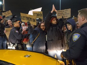 Protesters temporarily block an intersection near Terminal 4 at John F. Kennedy International Airport in New York on Saturday, Jan. 28, 2017.