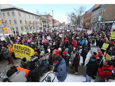 Protestors listen to speeches at the bottom of the York St Steps as an anti President Trump protest takes place at the Embassy of the United States in Ottawa.