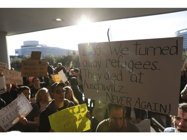 Demonstrators hold signs during a rally against a ban on Muslim immigration at San Francisco International Airport.