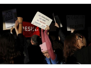 A demonstrator holds a sign during a rally against a ban on Muslim immigration at San Francisco International Airport.