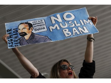 A woman holds a sign during a rally against a ban on Muslim immigration at San Francisco International Airport.