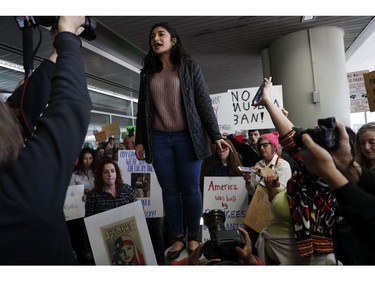 Kayla Razavi, whose family emigrated from Iran, addresses the crowd during a rally against a ban on Muslim immigration at San Francisco International Airport.