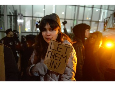 A protester holds up a simple sign at John F. Kennedy International Airport.