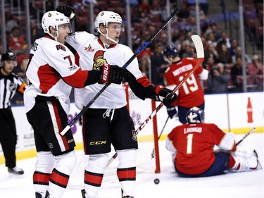 Ottawa Senators left wing Ryan Dzingel, center, and center Kyle Turris (7) celebrate after Dzingel scored against Florida Panthers goalie Roberto Luongo (1) during the first period of an NHL hockey game, Tuesday, Jan. 31, 2017, in Sunrise, Fla.
