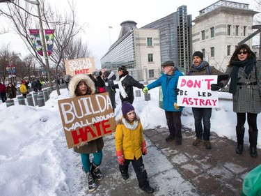 Roman and Seneca Chassin walk along side a human chain stretched along Mackenzie Avenue as an anti President Trump protest takes place at the Embassy of the United States in Ottawa.