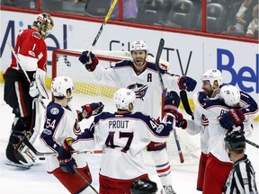 Ottawa Senators goaltender Mike Condon (1) looks on as the Columbus Blue Jackets' Scott Harrington (54) Dalton Prout (47), Bonne Jenner (38) and Brandon Dubinsky (17) celebrate after Cam Atkinson (13) scored during third period NHL hockey action in Ottawa on, Sunday January 22, 2017.