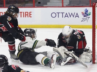 The Ajax Pickering Raiders' Ryan Harvery, left, shoves the Gloucester Rangers' Christopher Barlas into the Raiders' goaltender Minor Peewee AAA final.