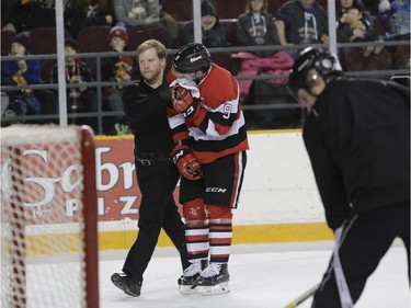 The Ottawa 67's Austen Keating leaves the ice after getting a facial injury.