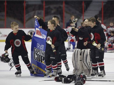 The St. Clair Shores Stars celebrate their victory over the Long Island Gulls in the Minor Atom AAA final.