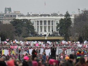 Demonstrators protest  near the White House in Washington, DC, for the Women's March on January 21, 2017. Hundreds of thousands of protesters spearheaded by women's rights groups demonstrated across the US to send a defiant message to US President Donald Trump. /