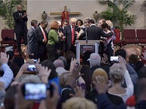 TOPSHOT - Pastors and attendees lay hands and pray over Republican presidential nominee Donald Trump during the Midwest Vision and Values Pastors and Leadership Conference at the New Spirit Revival Center in Cleveland Heights, Ohio on September 21, 2016. /