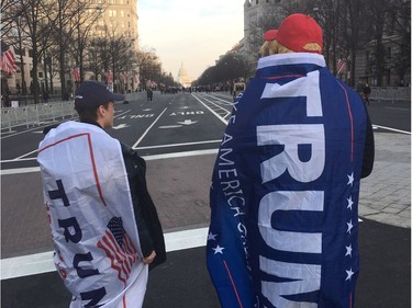 Two Trump supporters walk down Pennsylvania Avenue in Washington, D.C., on Thursday, Jan.19, 2017.