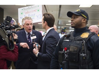 Virginia Gov. Terry McAuliffe delivers remarks to the media gathered at the international arrivals area of the Washington Dulles International Airport.