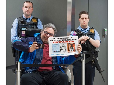 A protestor takes a photo inside the international arrivals area of the Washington Dulles International Airport.