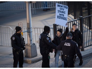 Protesters gather at JFK International Airport.