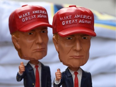 U.S. president-elect Donald Trump bobbleheads on sale outside the White House in Washington, D.C.,