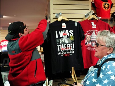 People shop souvenirs at a store in Washington, DC., on Jan. 19, 2017, where final preparations are underway a day ahead the inauguration of U.S. president-elect Donald Trump.