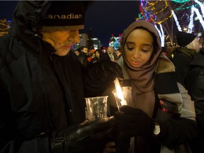 Edmontonians take part in a vigil in response to Sunday's deadly shooting at a Quebec City mosque, at the Alberta Legislature in Edmonton, Monday Jan. 30, 2017