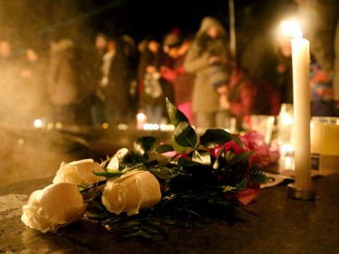 White roses and candles line the eternal flame in memory of the six people killed. More than 1,000 people came out to a candlelight vigil for the victims of the Quebec mosque attack Monday (Jan. 30, 2017) in front of Parliament Hill's eternal flame. Julie Oliver/Postmedia