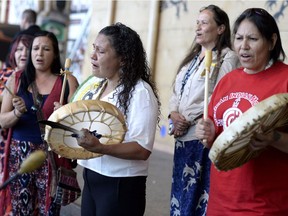 Women drum following the announcement of the inquiry into Murdered and Missing Indigenous Women at the Museum of History in Gatineau, Quebec on Wednesday, Aug. 3, 2016.