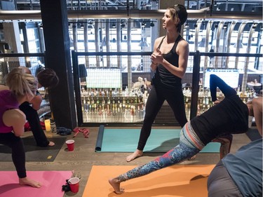 Yoga on Tap owner and head instructor Ashley Kokelj instructs the beer yoga class.