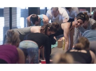 Yoga on Tap owner and head instructor Ashley Kokelj, right, instructs the beer yoga class.