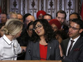 Member of Parliament Iqra Khalid is congratulated by colleagues as she makes an announcement about an anti-Islamophobia motion on Parliament Hill in Ottawa on Wednesday, February 15,