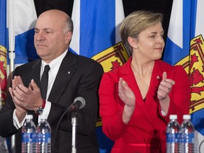 Kellie Leitch, right, and Kevin O'Leary applaud at the Conservative leadership candidates' debate, in Halifax on Saturday, Feb. 4, 2017. Conservatives vote for a new party leader on May 27, 2017.