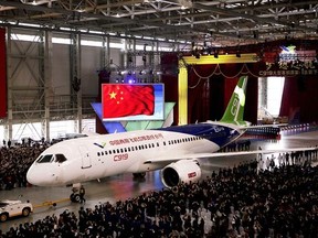 FILE - In this Monday, Nov. 2, 2015 file photo, the first twin-engine 158-seater C919 passenger plane made by The Commercial Aircraft Corp. of China (COMAC) is pulled out of the company&#039;s hangar during a ceremony near the Pudong International Airport in Shanghai, China. After years of delays, China&#039;s first large homemade passenger jetliner will take to the air for its maiden flight in the first half of this year, state media reported Monday, Feb. 6, 2017. (AP Photo, File)