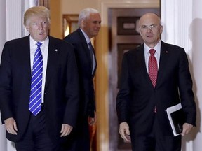 In this Nov. 19, 2016 file photo, President-elect Donald Trump walks Labor Secretary-designate Andy Puzder from Trump National Golf Club Bedminster clubhouse in Bedminster, N.J. Puzder said Tuesday, Feb. 7, 2017, that a housekeeper he had previously employed at his home was an undocumented worker, potentially complicating his efforts to get confirmed.