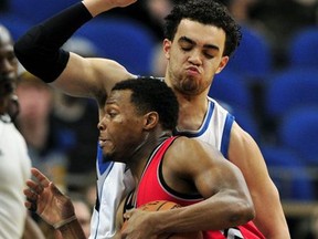 Minnesota Timberwolves guard Tyus Jones, back, defends against Toronto Raptors guard Kyle Lowry during the first quarter of an NBA basketball game on Wednesday, Feb. 8, 2017, in Minneapolis.