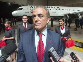 Air Canada CEO Cavin Rovinescu speaks to the media after unveiling the airline&#039;s new uniforms in front of new lettering on one of the company&#039;s planes in Montreal, Thursday, Feb.9, 2017. THE CANADIAN PRESS/Ryan Remiorz