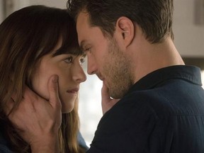 This image released by Universal Pictures shows Dakota Johnson as Anastasia Steele, left, and Jamie Dornan as Christian Grey in &ampquot;Fifty Shades Darker.&ampquot; (Doane Gregory/Universal Pictures via AP)