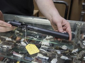 In this photo taken Jan. 31, 2017, a silencer is displayed at Ed&#039;s Public Safety gun shop in Stockbridge, Ga. They are the stuff of legend, wielded by hit men and by James Bond. For decades, buying a silencer for a firearm has been as difficult as buying a machine gun, requiring a background check that can take close to a year. Now, emboldened by the election of Donald Trump as president, the industry has renewed a push in Congress to ease those restrictions, arguing that it‚Äôll help preserve t