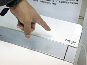 In this Monday, Feb. 13, 2017 photo, Zhong Jiye, a co-founder of Shenzhen Trump Industrial Co., points to the logo on one of his firm&#039;s high-end Trump-branded toilets at the company&#039;s offices in Shenzhen in southern China&#039;s Guangdong Province. U.S. President Donald Trump is poised to receive something that he had been trying to get from China for more than a decade: trademark rights to his own name. After suffering rejection after rejection in China&#039;s courts, he saw his prospects change dramatic