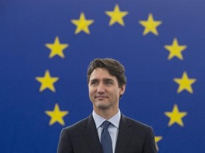 Canadian Prime Minister Justin Trudeau stands as he is introduced before addressing the European Parliament in Strasbourg, France, Thursday, February 16, 2017. THE CANADIAN PRESS/Adrian Wyld