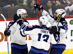 Winnipeg Jets&#039; Josh Morrissey (44) celebrates his goal against the Ottawa Senators with teammates Brandon Tanev (13) and Chris Thorburn (22) during third period NHL hockey action in Ottawa on, Sunday February 19, 2017. THE CANADIAN PRESS/Fred Chartrand